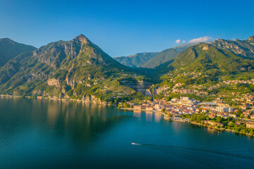 Marone, Lake Iseo. Aerial panoramic sunset view of Marone town surrounded by mountains and located in Iseo Lake, Brescia, Lombardy, Italy