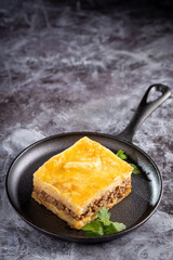 Piece of shepherd's pie on dark plate.