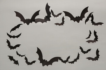 Frame made of paper bats for Halloween party on grey background