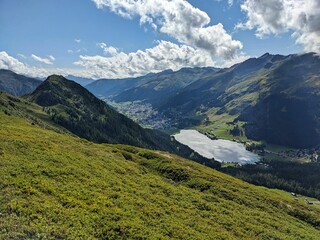 Fototapeta na wymiar Davos lake. Nice view of the mountain lake in Davos from the Huerli. Wanderlust in the Swiss mountains. High quality photo