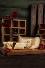 On the table is hard Dumbo cheese in a black shell