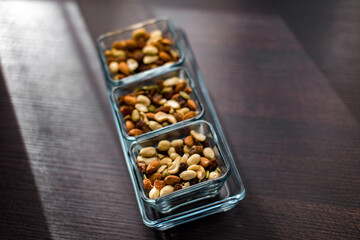 Raisins, peanuts and pistachio in elegant glass bowls