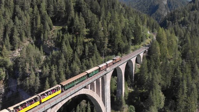 Wiesner Viaduct with historic train, crocodile loco, striking railway bridge, drone shots, Davos Wiesen, Graubuenden, Switzerland, Europe