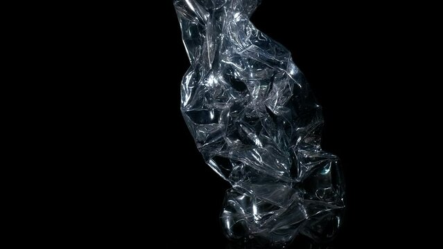 Bottle after using on black background. A view of spinning plastic bottle after using on the black background. A concept of eco movement and reuse plastic problems.