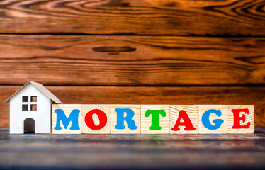 Wooden home and text on the cubes mortgage
