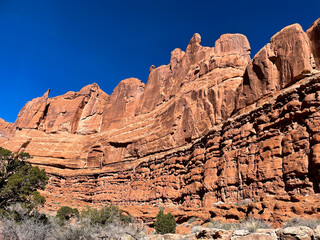 Fototapeta premium Moab, Utah, looking at the amazing rock formations created due to erosion from wind and water on the sandstone with Red Rock Cliffs carved by the Colorado River