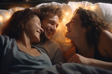 The concept of threesomes. A man and two women in love. Two women and a man in the same bed. Polygamy or bigamy. - obrazy, fototapety, plakaty