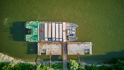 Aerial view of a ferry boat transport trucks, cars and people