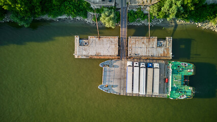 Aerial view of a ferry boat transport trucks, cars and people