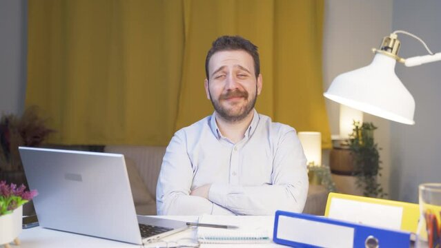 Home office worker man looking smugly at camera.