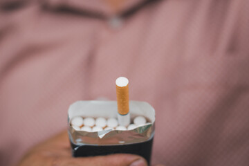 A smoker holding pack of cigarette for giving another people