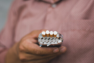 A smoker holding pack of cigarette for giving another people