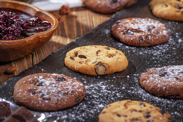 Cookies with chocolate and coffee on a wooden table, selective focus, close up