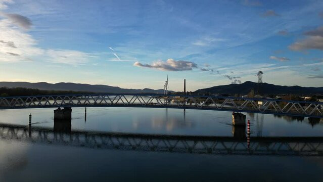 Panoramic view of a metal bridge over the Rhone river at sunrise in the south of France in the village of Le Pouzin (Ardeche)