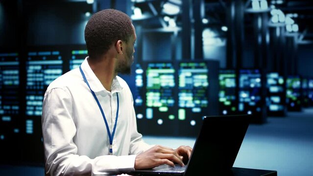 IT developer repairing server hub operational issues arising due to high CPU usage, insufficient memory, low disk space and misconfigured applications. Programmer overseeing performance trends