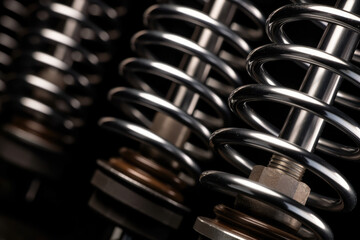 Close-up Macro Shot of a Brand New Shock Absorber with Shiny Metal Surface and Compressed Spring Coils - obrazy, fototapety, plakaty