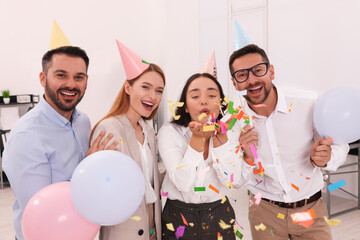 Coworkers having fun during office party indoors