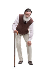 Senior man with walking cane suffering from knee pain on white background