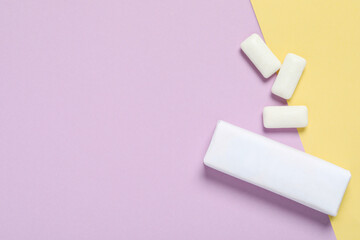 Pack with tasty chewing gums on color background, flat lay. Space for text