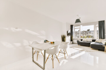 a living room with white flooring and large windows looking out onto the cityscapearl view from the dining area
