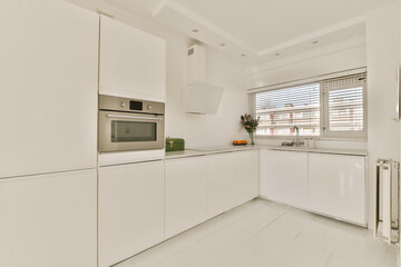 a kitchen with white cupboards and appliances on the counter top in an apartment development, melbourne, vic, australia
