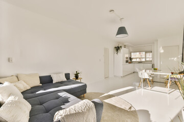 a living room with white walls and furniture in the fore - image is taken from an angle to show how...