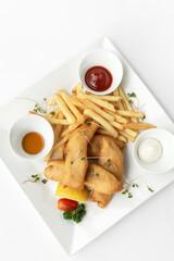 british traditional fish and chips meal in restaurant on white plate - 629752213