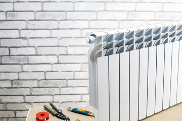 Heating radiator with tools against wall in the apartment. repair heating system concept. place for...