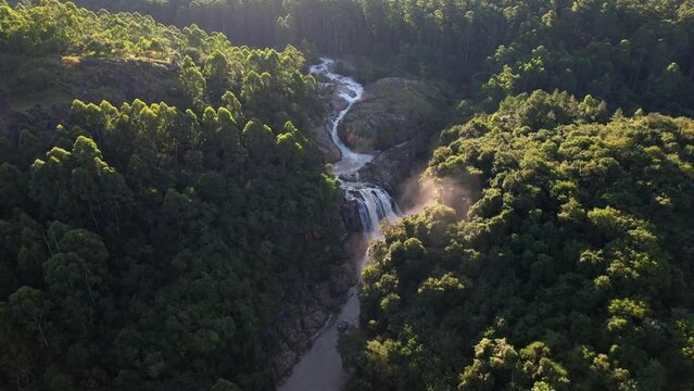 Birds eye view drone shot waterfall and river in rainforest in Africa
