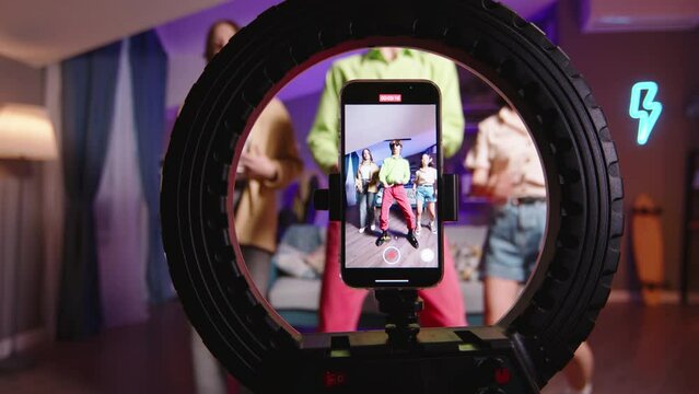 Three Gen Z friends record trending reels for social media with K-pop dance. Preparation viral trend dance from talented enthusiastic bloggers. Virtual life, look at my crush on social media tik tok