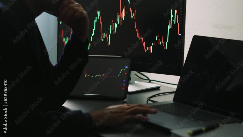 Aufkleber Back view of stock market broker in analyzing data and graphs on multiple computer screens while sitting in modern office.