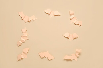 Frame made of bats made of paper for Halloween on beige background