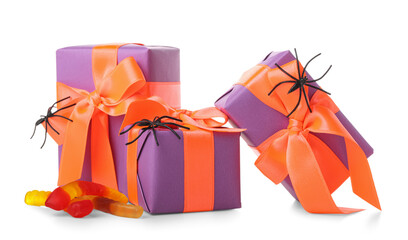 Spiders, tasty candies and gift boxes for Halloween on white background