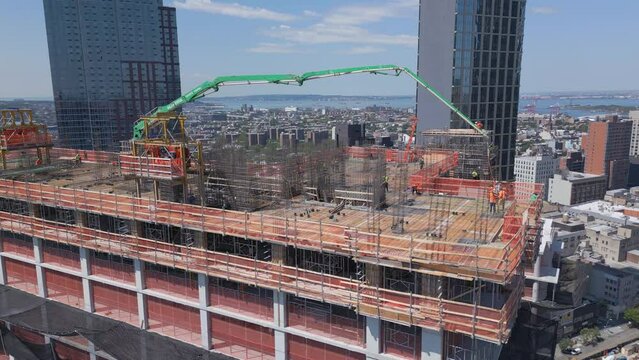 alt flying clockwise around crane atop skyscraper under construction in Brooklyn