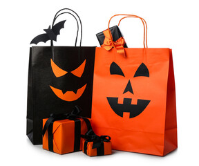 Different shopping bags and gift boxes for Halloween on white background