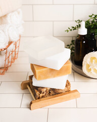 Handmade organic bar soaps on white tile background