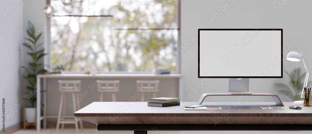 Poster a modern workspace with a computer mockup on a desk in a modern office co-working space.