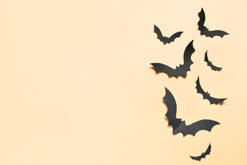 Paper bats for Halloween party on yellow background