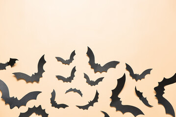 Paper bats for Halloween party on yellow background