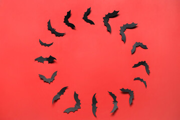 Frame made of paper bats for Halloween party on red background