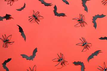 Frame made of paper bats and spiders for Halloween party on red background