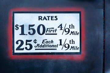 Old taxi rates on white background and framed with red and black color