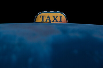 Taxi sign on black and blue background