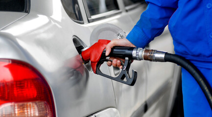 Woman hand refilling the car with fuel
