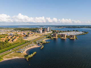 Almere Poort marina and the new residential neighbourhood with highrise apartment buildings in Almere, Flevoland, The Netherlands