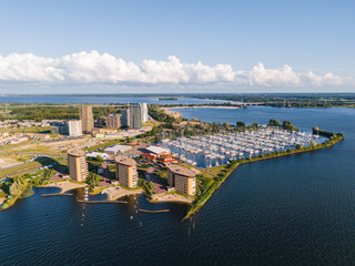 Almere Poort marina and the new residential neighbourhood with highrise apartment buildings in Almere, Flevoland, The Netherlands