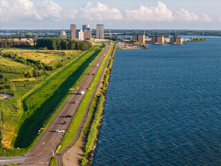 Flevoland polder dam with Almere Poort residential area on background