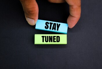 colored paper with the word stay tuned. the concept of wait a moment or continue with us