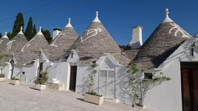 Alberobello Italy - traditional trulli houses with conical stone roofs. Famous landmark, travel destination and tourist attraction near Bari in Puglia, Europe.