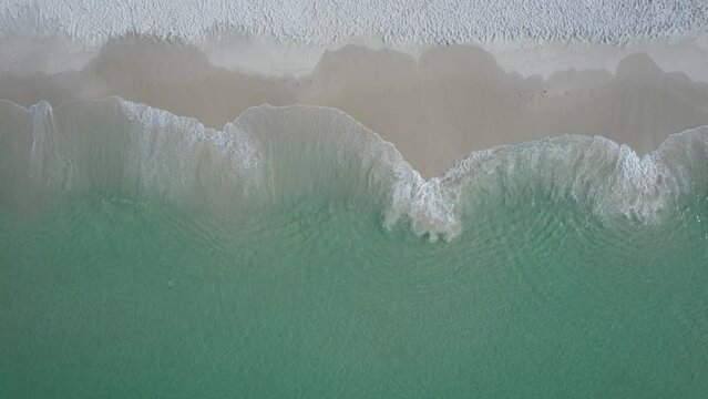 Aerial view of clear emerald waters of Gulf of Mexico Florida's white sand beach on a bright sunny day on the Gulf of Mexico